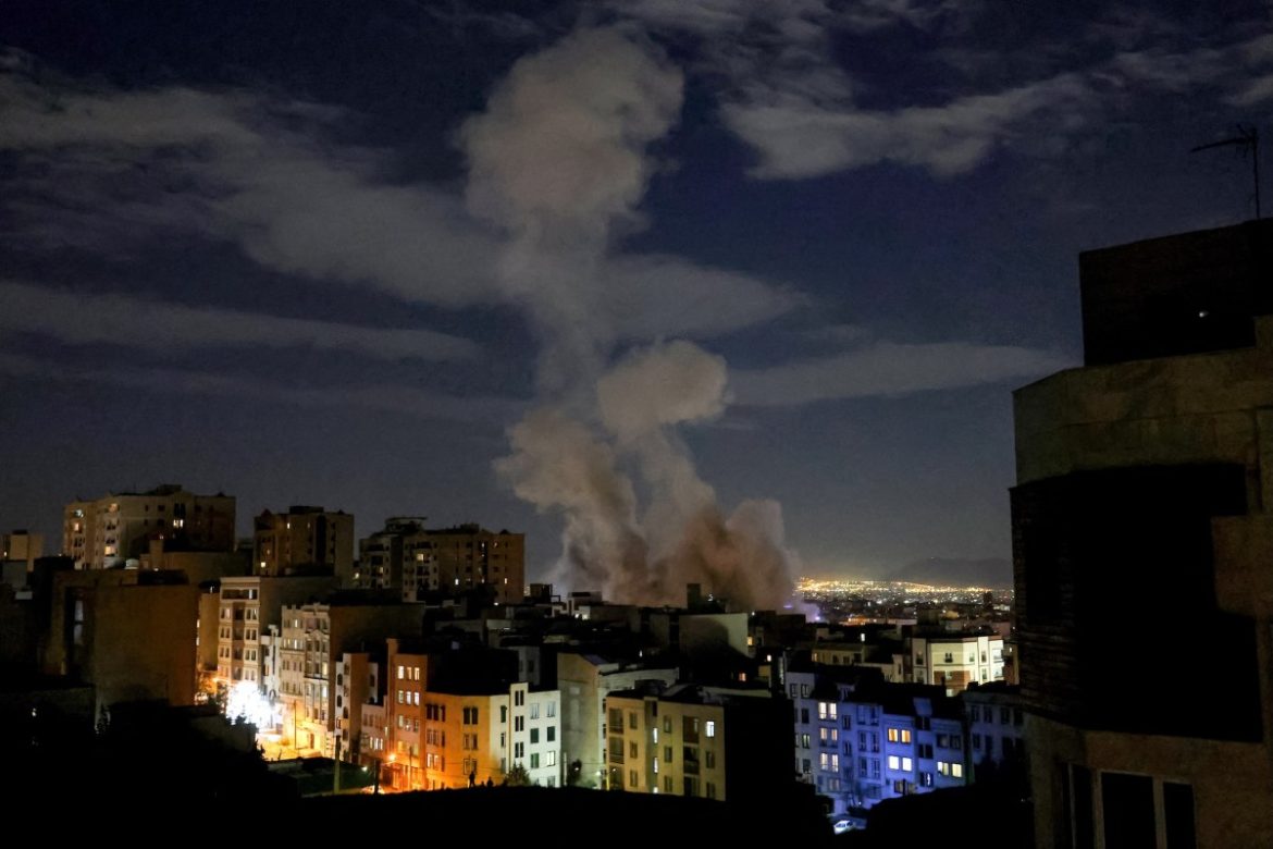 A smoke plume rises following a missile strike on a building in Tehran on March 1, 2026.
